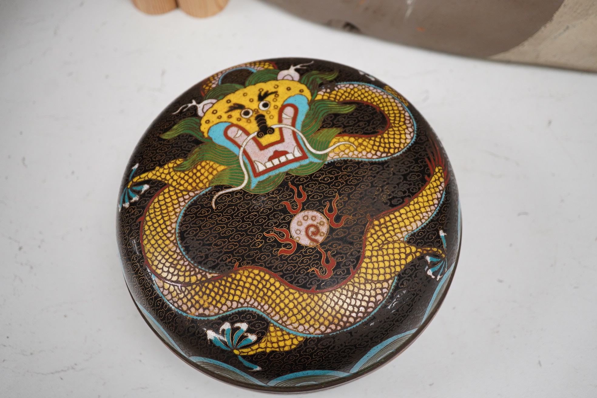 An early 20th century Chinese cloisonné enamel circular ‘dragon’ box and cover, 20cm diameter. Condition - good